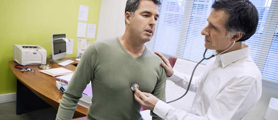 A licensed medical professional using a stethoscope to check a patient’s heart and lungs, illustrating clinical monitoring during medically supervised detox.